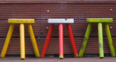 Photo of three legged stools in a row